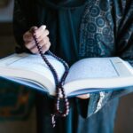 Crop Photo Of Woman Holding A Prayer Beads And Holy Book