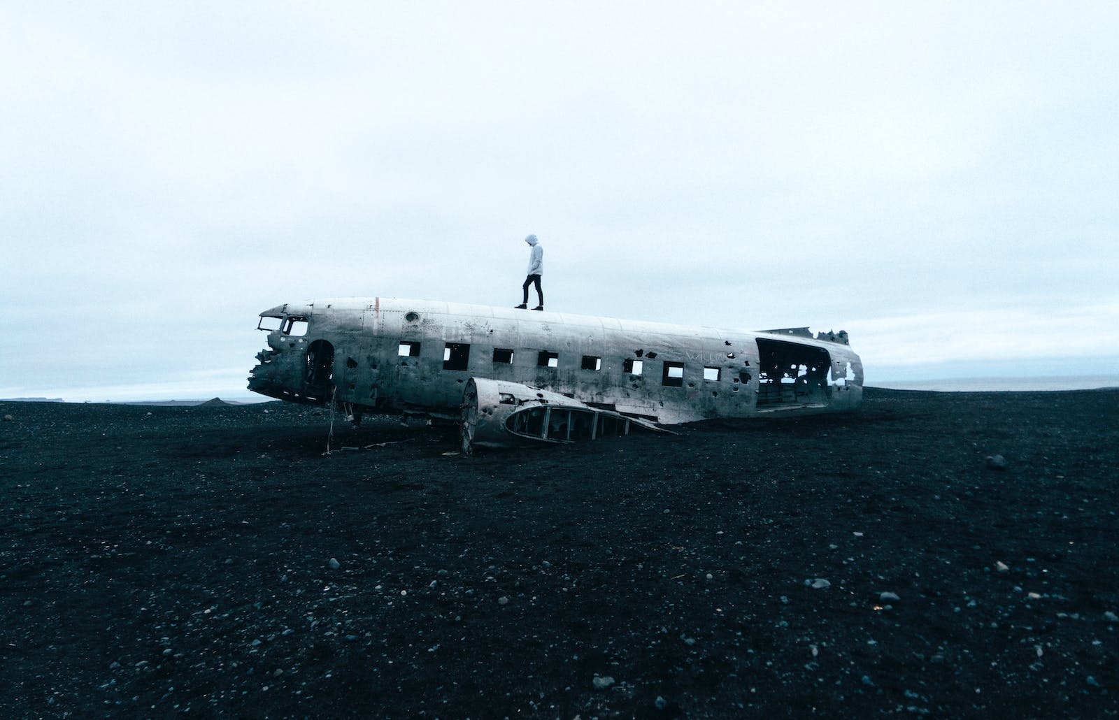 Person Standing on Wrecked Plane