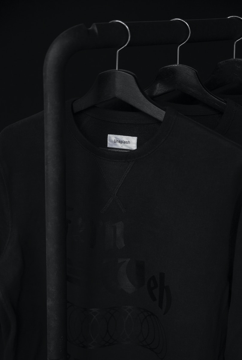black crew-neck t-shirt on clothes hanger