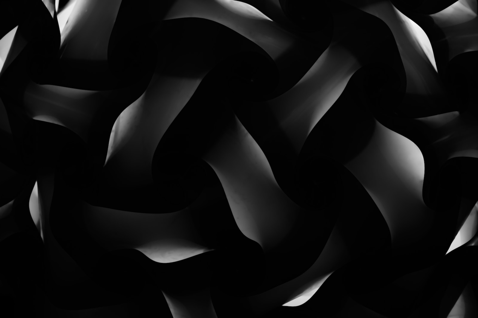 a black and white photo of a bunch of wavy shapes