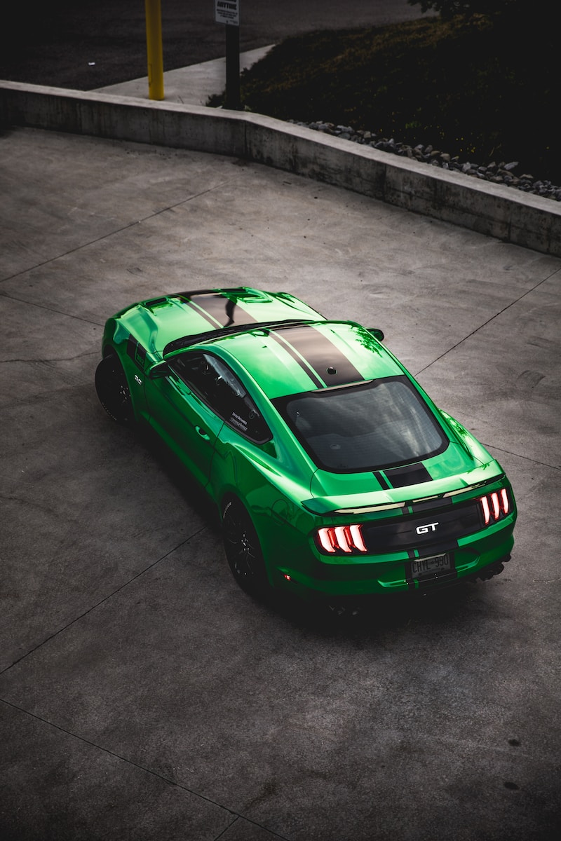 green Ford Mustang on road