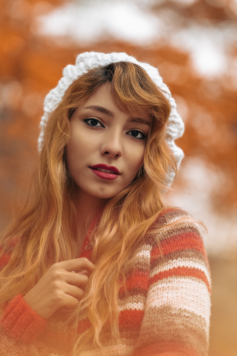 portrait of woman wearing red and white sweater