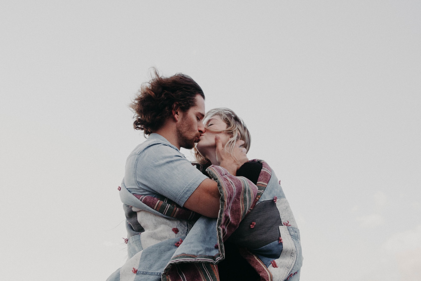 low angle photograph of man and woman kissing