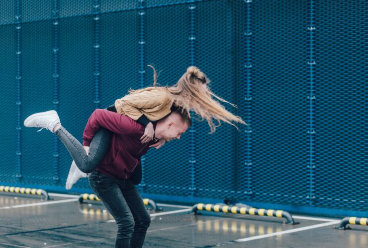 man carrying woman on back