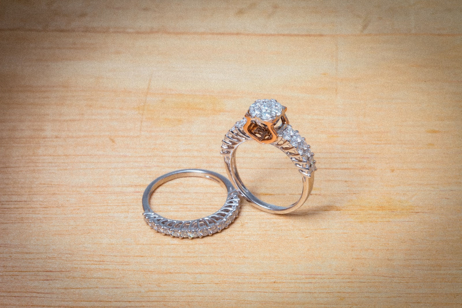 silver and diamond ring on brown wooden table