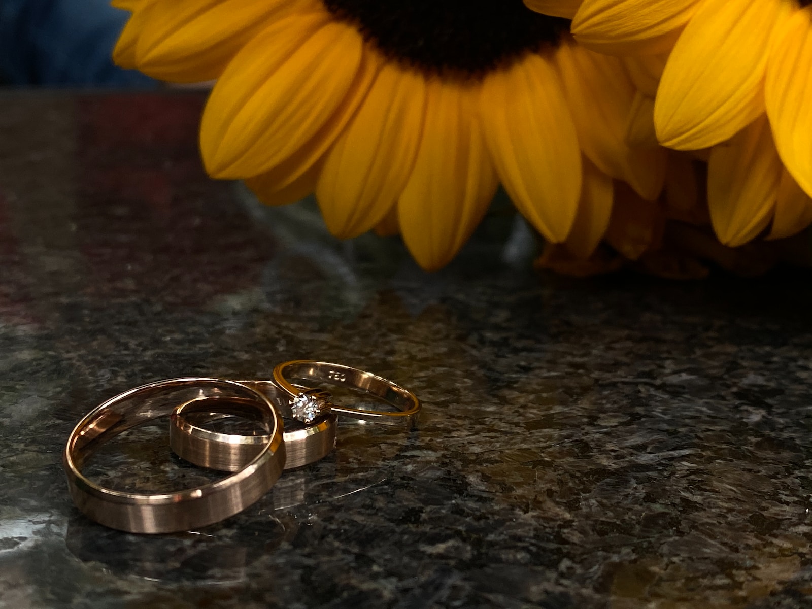 silver-colored ring and yellow Sunflowers