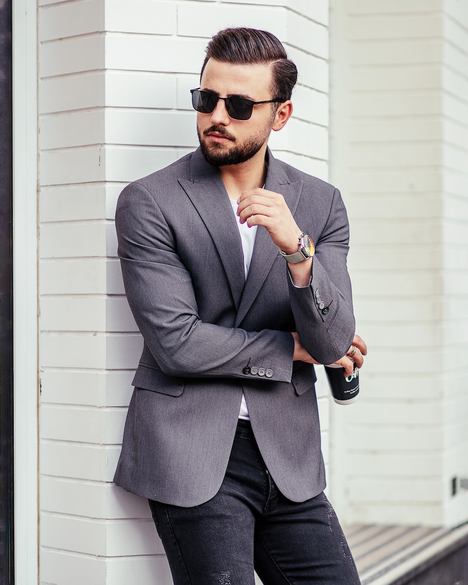 man in gray suit jacket wearing black sunglasses