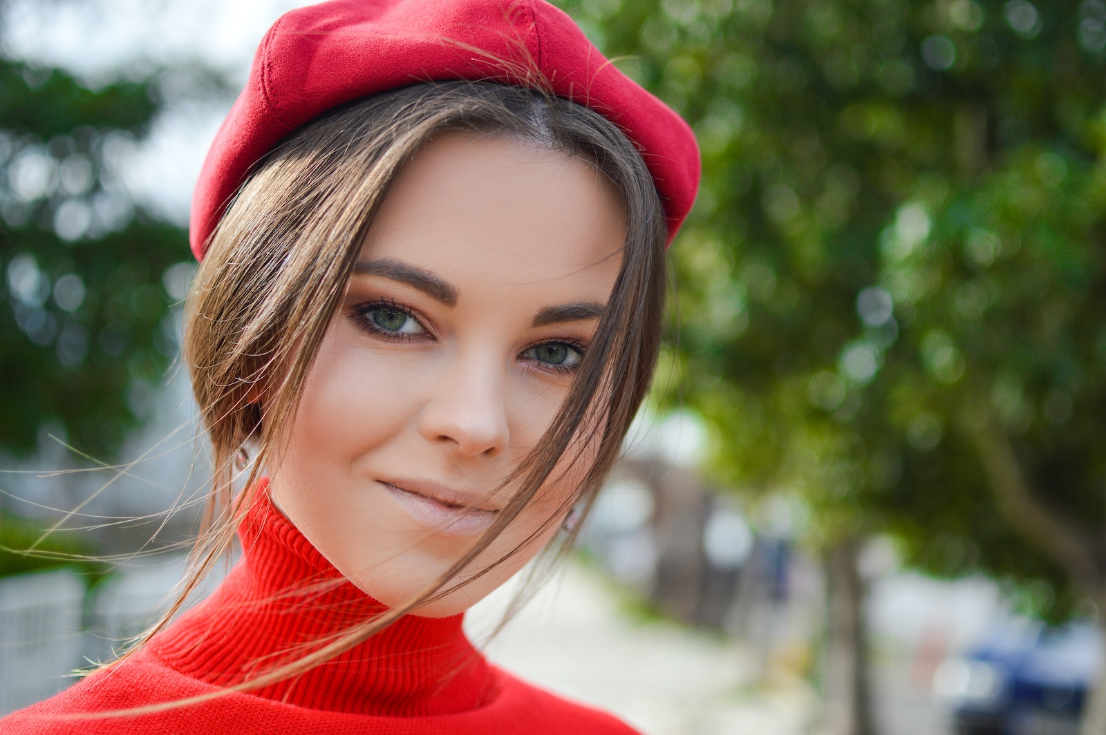 closeup photo of woman wearing red cap